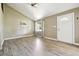 Open-concept living room with wood-look flooring, vaulted ceiling, and natural light from a window at 180 S Lamar St, Lakewood, CO 80226