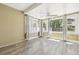 Bright sunroom with multiple windows offering natural light, a ceiling fan, and wood-look flooring at 180 S Lamar St, Lakewood, CO 80226
