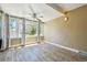 Sunroom showcasing multiple windows for ample natural light, a ceiling fan, and wood-look flooring at 180 S Lamar St, Lakewood, CO 80226