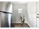 Clean utility area featuring modern stainless steel refrigerator and newer plumbing at 180 S Lamar St, Lakewood, CO 80226