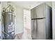 Utility area featuring new stainless steel refrigerator and updated water heater at 180 S Lamar St, Lakewood, CO 80226