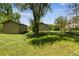 The home's exterior and expansive backyard with plenty of shade from mature trees at 180 S Lamar St, Lakewood, CO 80226