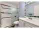 Well-lit bathroom with a modern vanity, sleek fixtures, and a glass-enclosed shower at 547 S Flower St, Lakewood, CO 80226