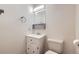 Bathroom featuring a simple vanity and lighting, and a white toilet and walls at 547 S Flower St, Lakewood, CO 80226