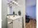 Bright bathroom featuring a modern vanity, brushed nickel fixtures, and an adjacent bedroom at 547 S Flower St, Lakewood, CO 80226