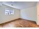 The naturally lit bedroom features wood floors, neutral walls, and a cozy window at 547 S Flower St, Lakewood, CO 80226