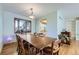 Inviting dining room featuring a bay window and a large, extendable wooden table for Gathering gatherings at 547 S Flower St, Lakewood, CO 80226