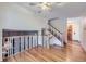 Bright foyer with hardwood floors, staircase, and white railings, offering an open and airy feel at 547 S Flower St, Lakewood, CO 80226