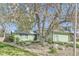 Landscaped front yard featuring a large tree and well-maintained lawn at 547 S Flower St, Lakewood, CO 80226