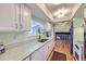 Bright kitchen featuring white cabinets, laminate countertops, and modern appliances at 547 S Flower St, Lakewood, CO 80226
