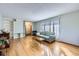 Inviting living room featuring hardwood floors, large window, and comfortable seating at 547 S Flower St, Lakewood, CO 80226