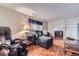 Comfortable living room with a cozy fireplace, built-in shelving, and plush seating at 547 S Flower St, Lakewood, CO 80226