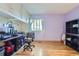 Bright home office featuring hardwood floors, built-in cabinets, and a spacious desk area at 547 S Flower St, Lakewood, CO 80226