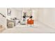 Basement living room features stylish seating and adjacent wet bar at 8230 W Tennessee Ct, Lakewood, CO 80226