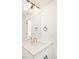 Bathroom featuring a modern vanity with gold hardware, quartz countertop, and decorative lighting at 8230 W Tennessee Ct, Lakewood, CO 80226