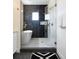 Sleek bathroom featuring walk-in shower, free standing tub, and sophisticated tile work at 8230 W Tennessee Ct, Lakewood, CO 80226