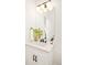 Elegant bathroom features white cabinets, quartz countertop, black fixtures, and stylish decor at 8230 W Tennessee Ct, Lakewood, CO 80226