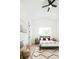 Cozy bedroom with neutral tones, a patterned rug, and natural light from a large window at 8230 W Tennessee Ct, Lakewood, CO 80226