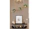 Stylish decorative wall with floating shelves, modern artwork, and accent lighting at 8230 W Tennessee Ct, Lakewood, CO 80226