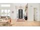 Elegant foyer with a modern chandelier, stylish console table, hardwood floors, and a striking front door at 8230 W Tennessee Ct, Lakewood, CO 80226