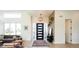 Welcoming foyer with modern light fixture, stylish decor, and light-filled atmosphere at 8230 W Tennessee Ct, Lakewood, CO 80226