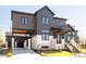 Beautiful modern exterior featuring a black garage door, concrete driveway, and sleek design at 8230 W Tennessee Ct, Lakewood, CO 80226