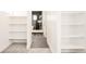 Hallway featuring a walk-in closet and bathroom with modern tile and glass shower at 8230 W Tennessee Ct, Lakewood, CO 80226