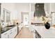 Bright kitchen featuring sleek countertops, stainless steel appliances, and modern cabinetry at 8230 W Tennessee Ct, Lakewood, CO 80226
