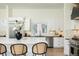 Bright kitchen featuring quartz counters, stainless appliances and a large island and bar seating at 8230 W Tennessee Ct, Lakewood, CO 80226