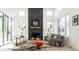 Inviting living room features a striking stone fireplace, bright windows and stylish decor at 8230 W Tennessee Ct, Lakewood, CO 80226