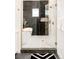 Main bathroom features a glass shower, standalone tub, and modern black and white tile design at 8230 W Tennessee Ct, Lakewood, CO 80226