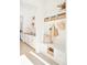 Well-organized mudroom with white cabinets, open shelving, drawers, a bench, and stylish decor at 8230 W Tennessee Ct, Lakewood, CO 80226