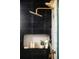 Shower detail showcasing bronze fixtures, tile and decorative niche at 8230 W Tennessee Ct, Lakewood, CO 80226