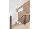 Modern staircase with metal railings, wood stairs, stylish lighting, and decor at 8230 W Tennessee Ct, Lakewood, CO 80226