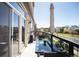 Outdoor balcony with a glass table, seating, and views of the surrounding neighborhood at 5677 S Park Pl # B310, Englewood, CO 80111