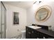 Updated bathroom features a designer mirror, modern vanity, and decorative floor tiling at 5677 S Park Pl # B310, Englewood, CO 80111