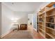 Hallway space features hardwood floors, built in bookshelves, a side table and decorative rug at 5677 S Park Pl # B310, Englewood, CO 80111