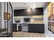 Home office area includes built in shelving, dark cabinetry, and a wraparound desk at 5677 S Park Pl # B310, Englewood, CO 80111