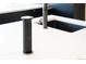 Close up of a kitchen island with a pop up outlet, sink, and modern faucet at 5677 S Park Pl # B310, Englewood, CO 80111