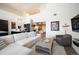 A spacious living room features a modern staircase, high ceilings, and an open-concept design at 5677 S Park Pl # B310, Englewood, CO 80111