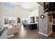 Bright living room with island kitchen, tall windows and spiral staircase to upper level at 5677 S Park Pl # B310, Englewood, CO 80111