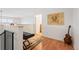 Loft area with an electric keyboard and decorative rug, hardwood floors, and natural light at 5677 S Park Pl # B310, Englewood, CO 80111