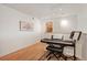 Loft area features hardwood flooring, an electric keyboard and access to a storage area at 5677 S Park Pl # B310, Englewood, CO 80111
