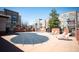 Community pool has lounge chairs on the pool deck surrounded by the buildings in the community at 5677 S Park Pl # B310, Englewood, CO 80111