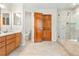 Bright bathroom features a double sink vanity, walk-in shower and soaking tub at 6310 W Sumac Ave, Littleton, CO 80123