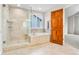 Lovely bathroom with a walk-in shower, soaking tub, and plenty of natural light at 6310 W Sumac Ave, Littleton, CO 80123