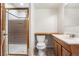 Compact bathroom with shower stall, toilet, and single sink vanity at 6310 W Sumac Ave, Littleton, CO 80123