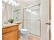 Clean bathroom featuring a glass enclosed shower, updated vanity, and a neutral color palette at 6310 W Sumac Ave, Littleton, CO 80123