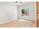 Bright bedroom with hardwood floors, neutral paint, and a large window at 6310 W Sumac Ave, Littleton, CO 80123