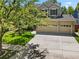 Charming two-story home featuring a well-manicured lawn, mature trees, and an attached two car garage at 6310 W Sumac Ave, Littleton, CO 80123